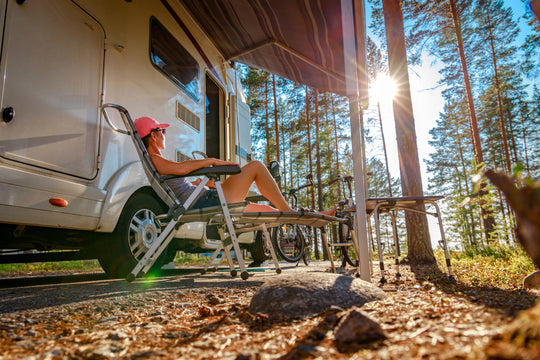 woman watches sunset with RV